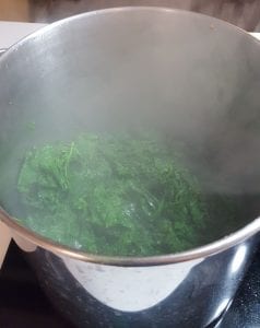Mustard greens cooked down by 50% after 5 minutes.