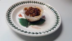 Mini pecan pie on dessert plate.