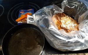Setting up a roast to bake in a Crockpot.