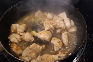 Browning the chicken in a skillet.