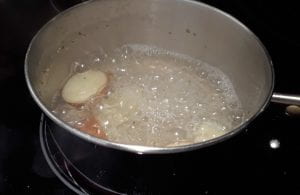 Boiling red potatoes.