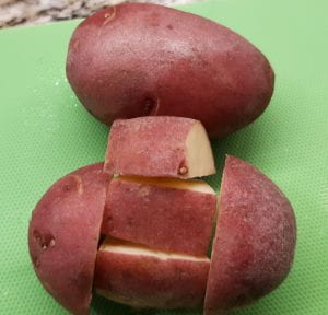 Cut each red potato into 5 pieces.