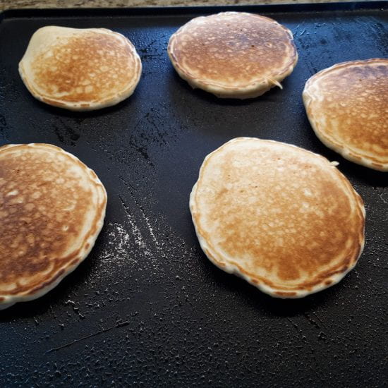 Pancakes cooking on bottom side.