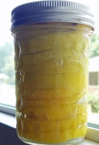 a jar of preserved lemons in a window