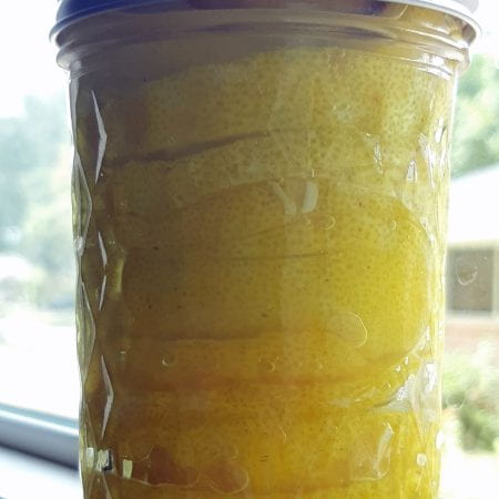 a jar of preserved lemons in a window