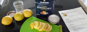 sliced lemons in front of  a box of salt